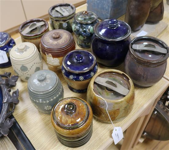 Twelve Doulton tobacco jars and covers, various designs